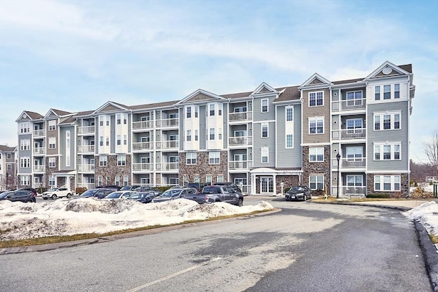 view of building exterior featuring uncovered parking