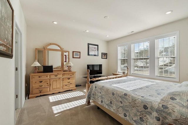 bedroom with recessed lighting, light colored carpet, and visible vents