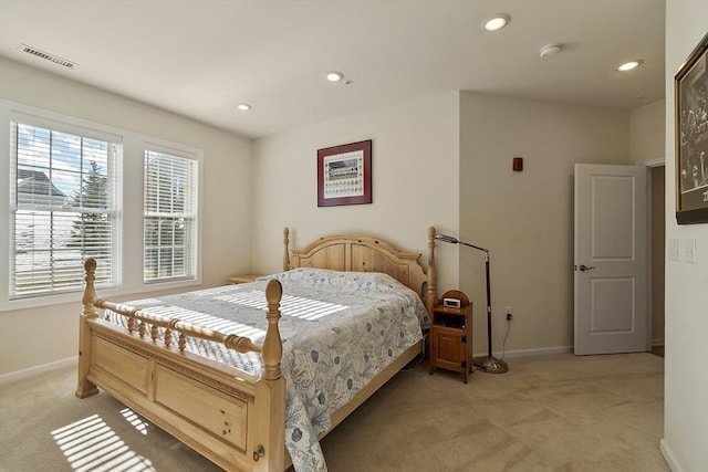 bedroom with multiple windows, recessed lighting, visible vents, and light colored carpet