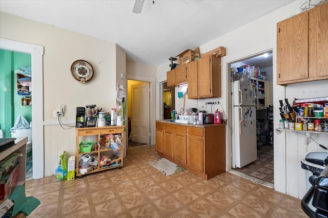 kitchen with white fridge and ceiling fan