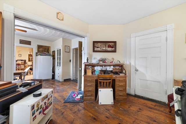 home office with dark hardwood / wood-style floors