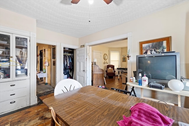 dining area featuring ceiling fan, a textured ceiling, and dark hardwood / wood-style flooring