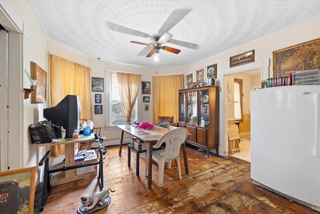 dining space with dark hardwood / wood-style flooring, a textured ceiling, and ceiling fan