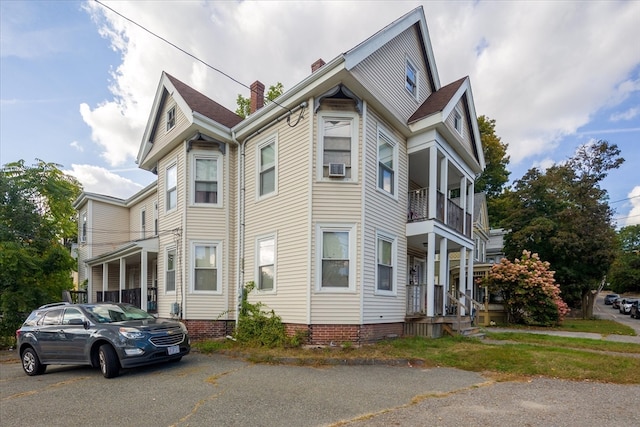 view of front facade with a balcony and a porch