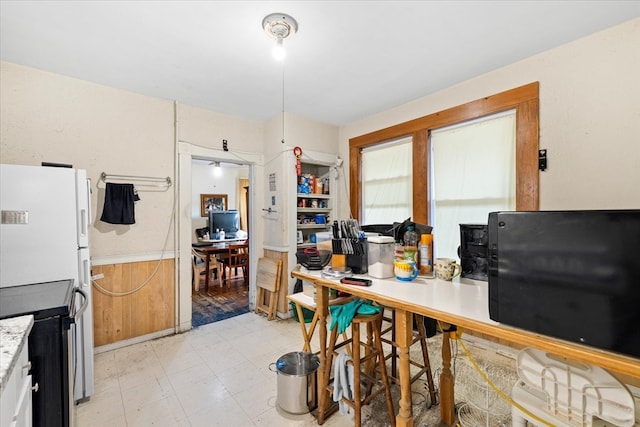 kitchen with white fridge and stainless steel electric range