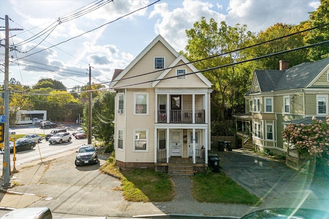 view of front of property with a balcony and a porch