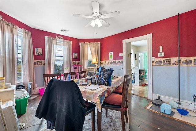 dining room with ceiling fan and dark hardwood / wood-style flooring