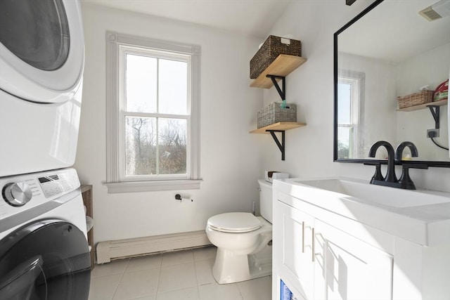 half bath with tile patterned flooring, visible vents, toilet, stacked washer / drying machine, and a baseboard radiator