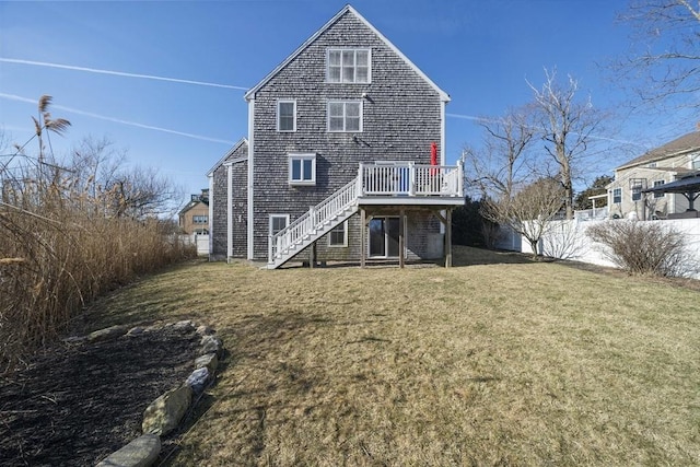 rear view of house with a deck, stairs, a yard, and fence