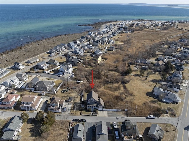 drone / aerial view featuring a residential view, a view of the beach, and a water view