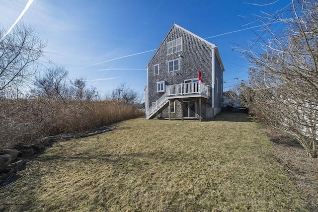 back of house featuring stairway, a lawn, and a deck