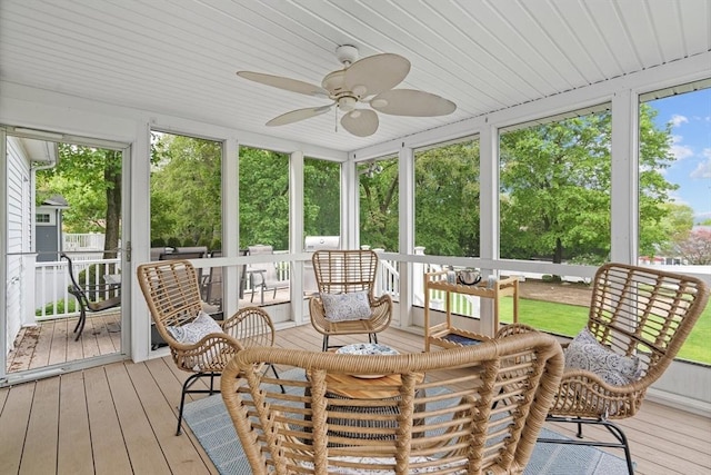sunroom / solarium with healthy amount of natural light and a ceiling fan