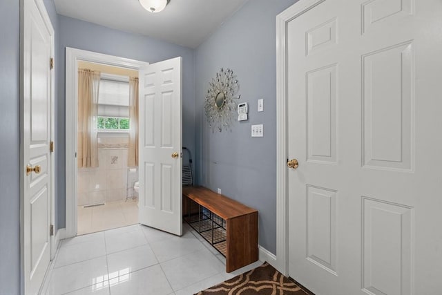entrance foyer featuring baseboards and light tile patterned floors