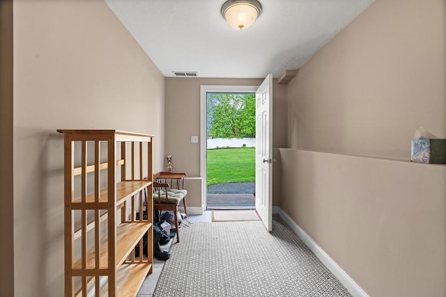 entryway with light carpet and baseboards