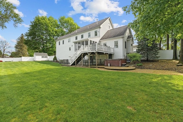 rear view of property with a hot tub, stairs, a storage shed, a wooden deck, and an outdoor structure