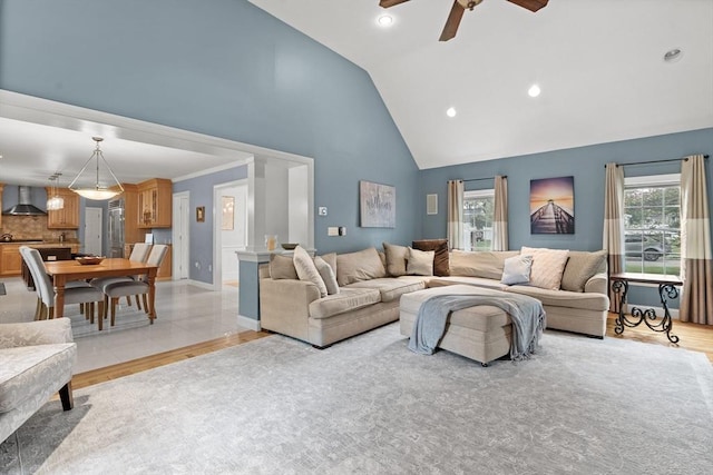 living area featuring a ceiling fan, high vaulted ceiling, light wood finished floors, and recessed lighting
