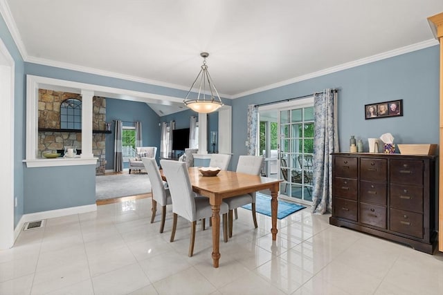 dining area featuring healthy amount of natural light, crown molding, baseboards, ornate columns, and light tile patterned floors