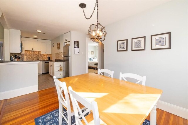 345 Ashmont St Unit 3, Boston, MA 02124 - dining area featuring an inviting chandelier, wood finished floors, baseboards, and recessed lighting