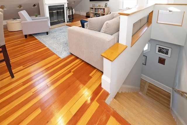345 Ashmont St Unit 3, Boston, MA 02124 - living room featuring baseboards, light wood finished floors, and a fireplace with flush hearth