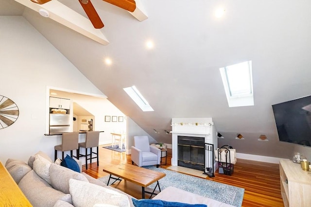 345 Ashmont St Unit 3, Boston, MA 02124 - living area featuring lofted ceiling with skylight, baseboards, and wood finished floors