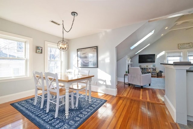 345 Ashmont St Unit 3, Boston, MA 02124 - dining room featuring a notable chandelier, baseboards, visible vents, and wood finished floors