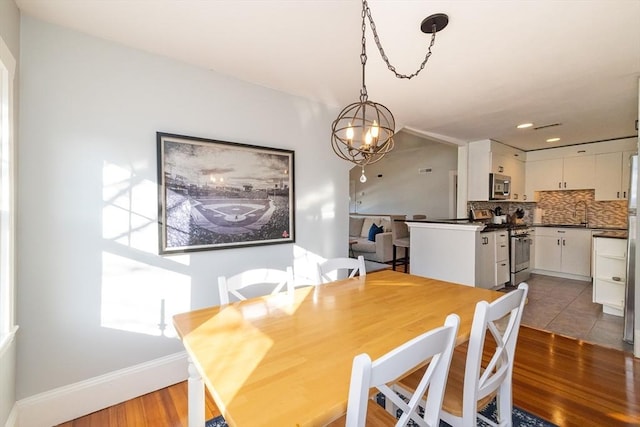 345 Ashmont St Unit 3, Boston, MA 02124 - dining space featuring baseboards, a chandelier, recessed lighting, and wood finished floors