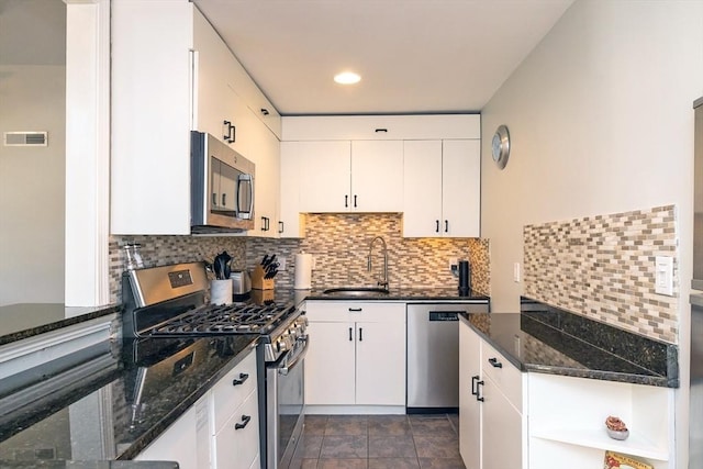 345 Ashmont St Unit 3, Boston, MA 02124 - kitchen featuring a sink, stainless steel appliances, dark stone counters, visible vents, and white cabinetry