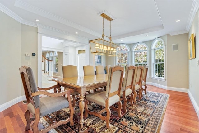 dining room with light wood-type flooring, baseboards, recessed lighting, crown molding, and stairs
