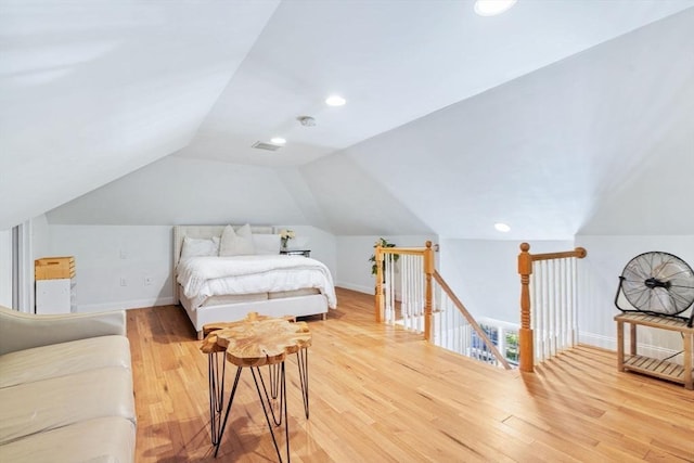 bedroom with light wood-style floors, lofted ceiling, baseboards, and recessed lighting