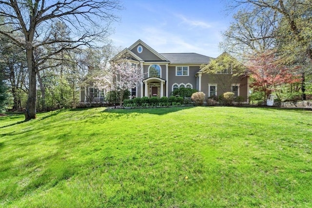 traditional-style home with a front yard