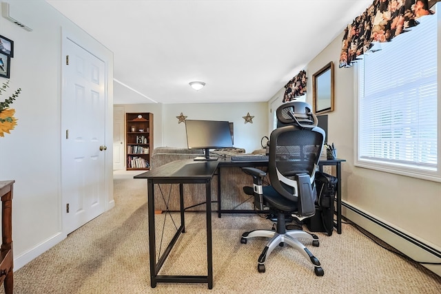 office space with light carpet and a baseboard heating unit