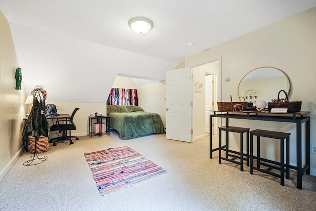 bedroom featuring carpet and lofted ceiling