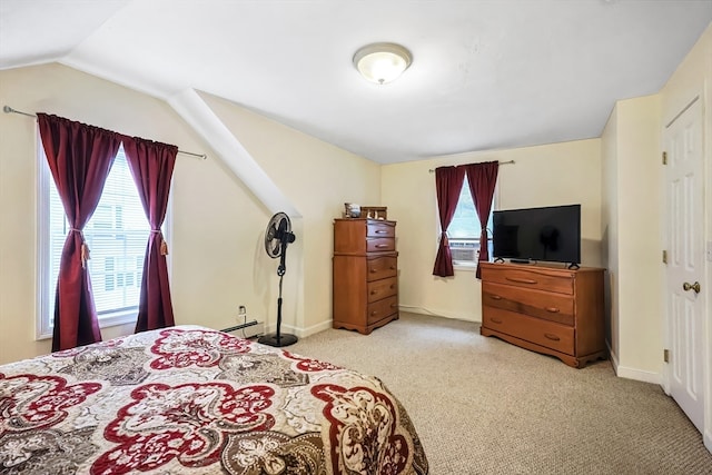 carpeted bedroom featuring vaulted ceiling and a baseboard radiator