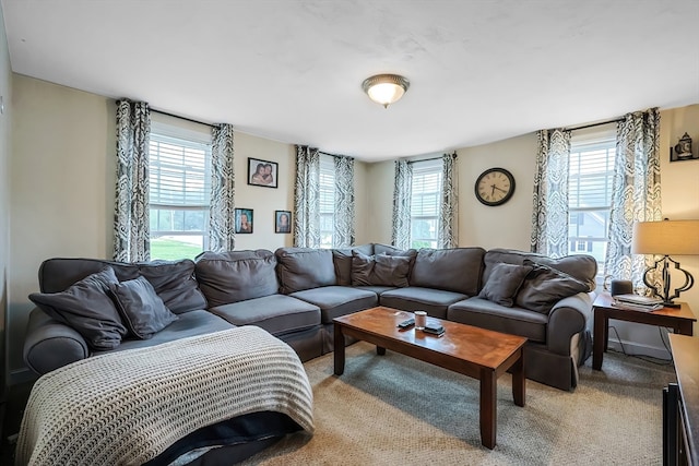 living room featuring carpet floors and a healthy amount of sunlight