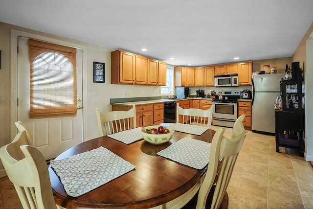 dining space featuring light tile patterned flooring and sink