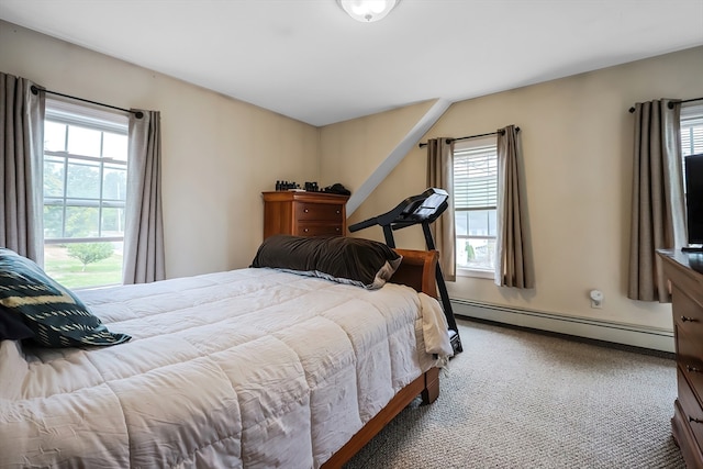 carpeted bedroom with a baseboard heating unit