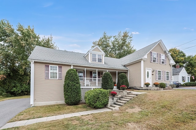 cape cod-style house with covered porch and a front yard