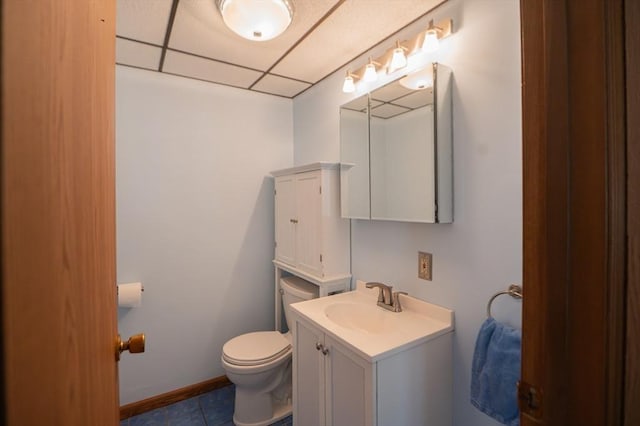 bathroom with toilet, baseboards, tile patterned flooring, and vanity