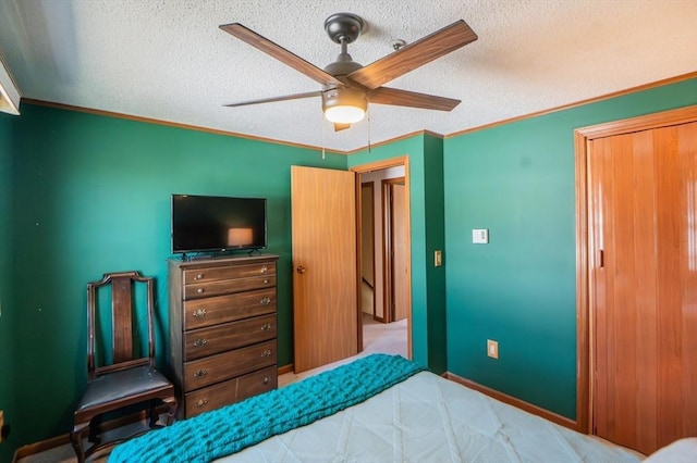 bedroom with ornamental molding, carpet, a textured ceiling, and ceiling fan