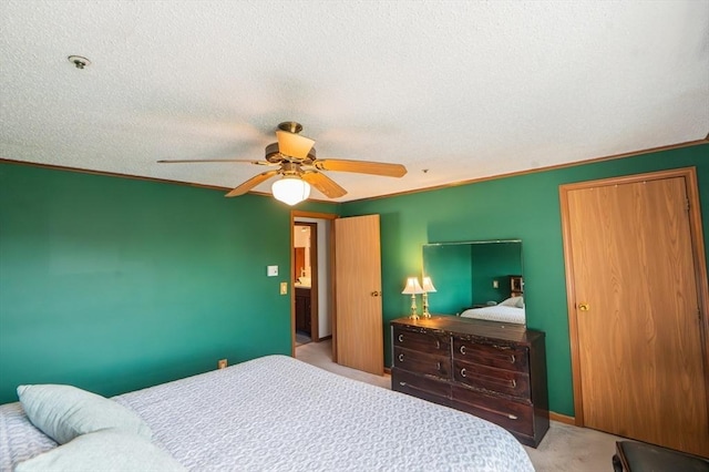 bedroom with a textured ceiling, a ceiling fan, and carpet floors