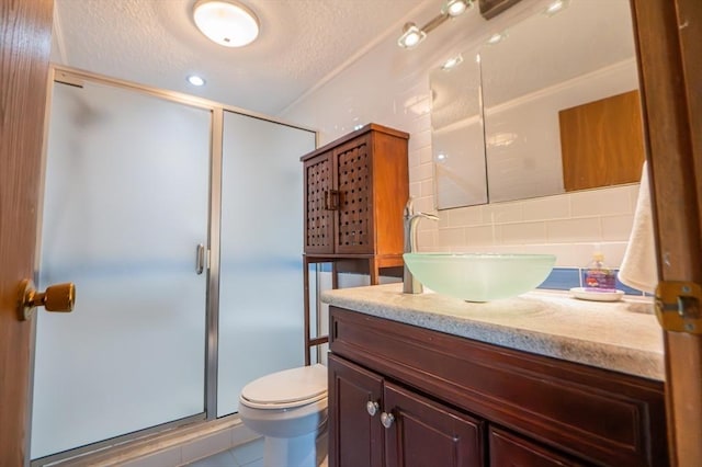 full bath featuring vanity, a textured ceiling, decorative backsplash, and a stall shower