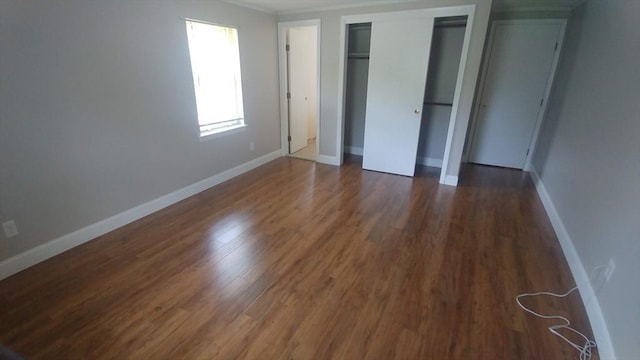 unfurnished bedroom featuring dark wood-type flooring