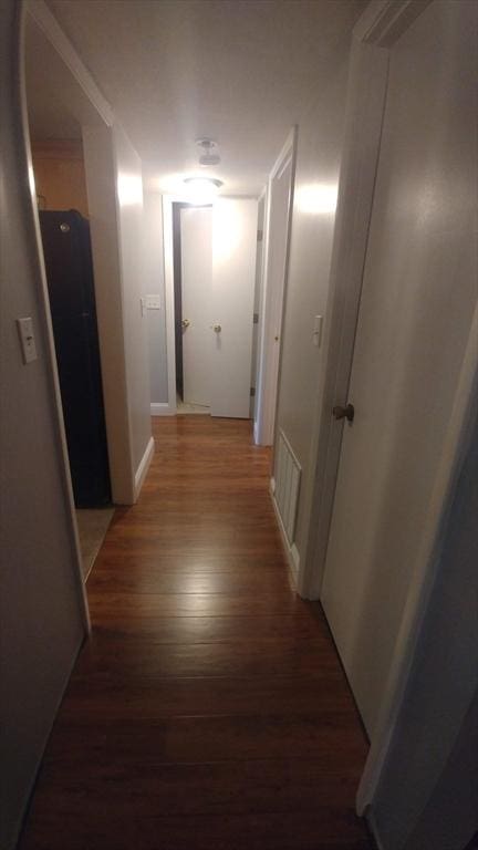 corridor with dark wood-type flooring