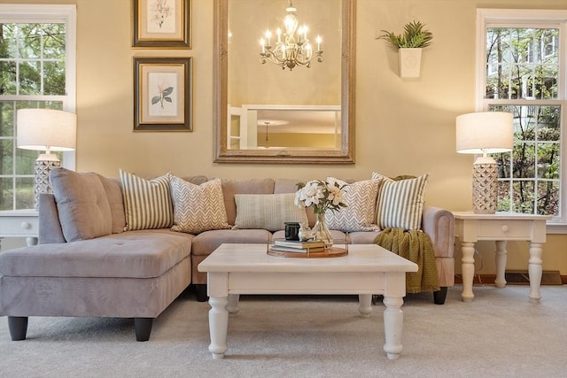 carpeted living area with a chandelier and plenty of natural light