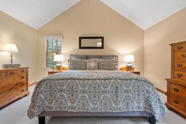 carpeted bedroom with lofted ceiling and baseboards