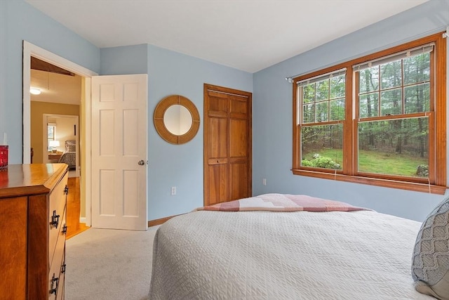 carpeted bedroom featuring baseboards