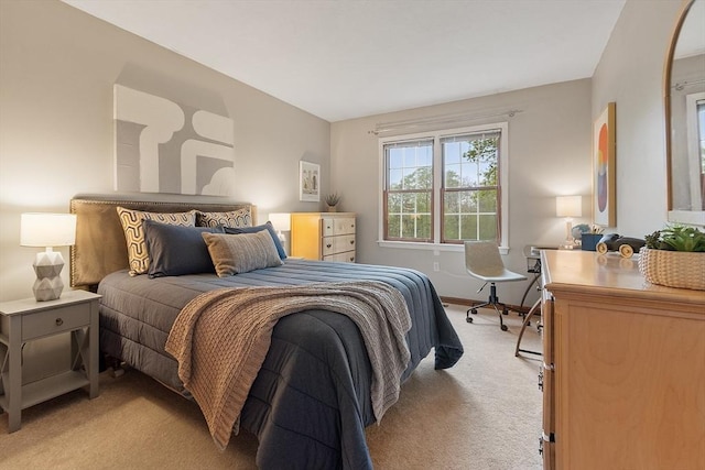 bedroom featuring light carpet and baseboards
