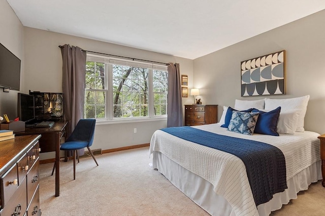 bedroom featuring light colored carpet and baseboards