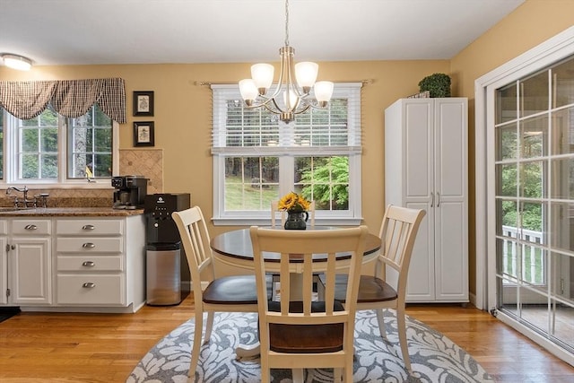dining space with a chandelier and light wood finished floors