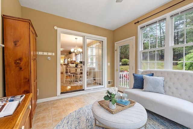 sunroom featuring a chandelier